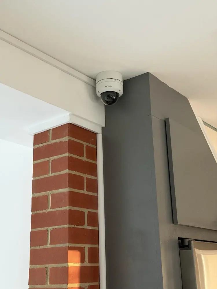 Interior dome camera mounted in a ceiling corner